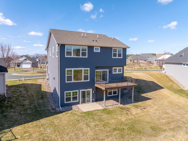 rear view of house featuring a lawn, a patio area, a residential view, and a deck