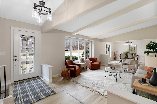 living room with wood finished floors, visible vents, baseboards, lofted ceiling with beams, and a chandelier