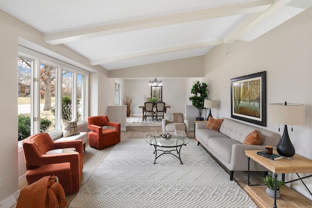 living area with wood finished floors, vaulted ceiling with beams, and baseboards
