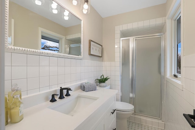 bathroom featuring tile walls, tile patterned flooring, a shower stall, and toilet