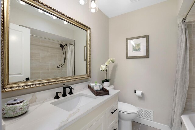 bathroom featuring visible vents, toilet, vanity, and tile patterned floors