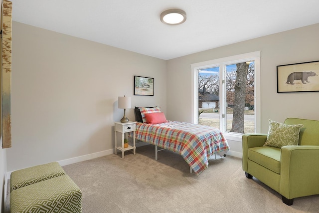 bedroom with light carpet and baseboards
