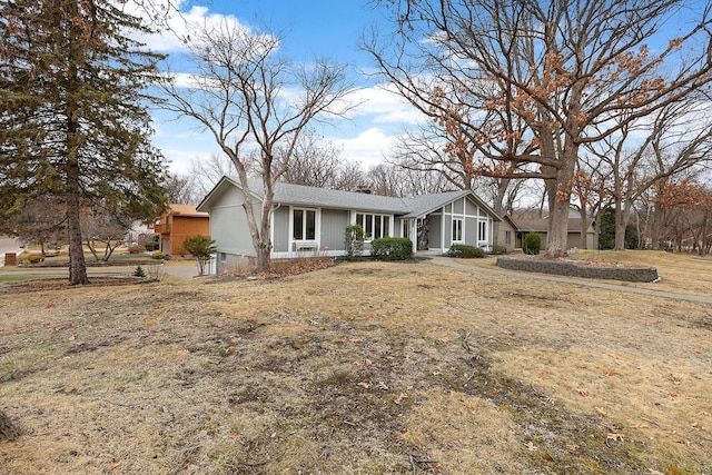 single story home with a chimney and roof with shingles