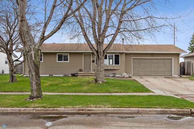 ranch-style home featuring an attached garage, driveway, a front yard, and entry steps