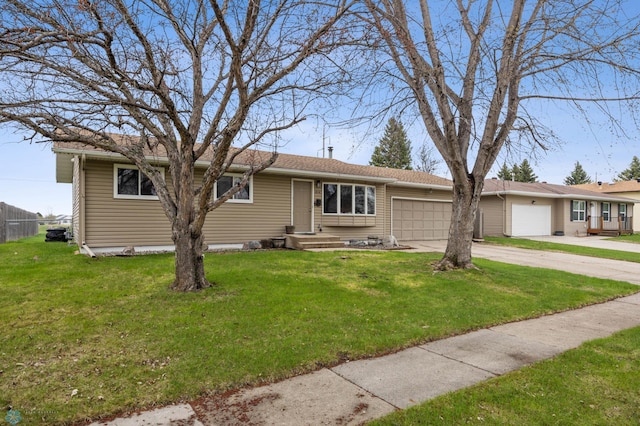 ranch-style house featuring an attached garage, driveway, and a front lawn