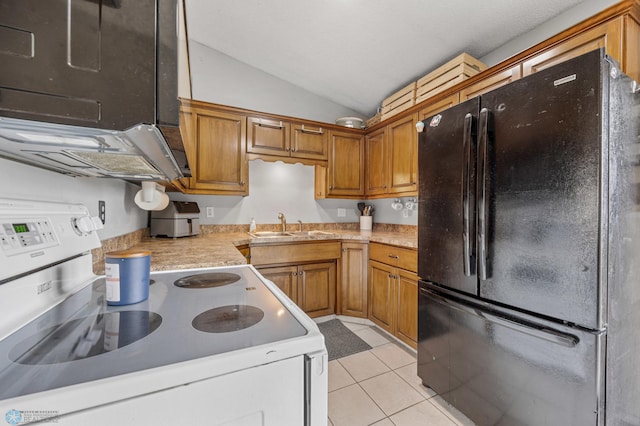 kitchen with freestanding refrigerator, electric range oven, a sink, light countertops, and light tile patterned floors