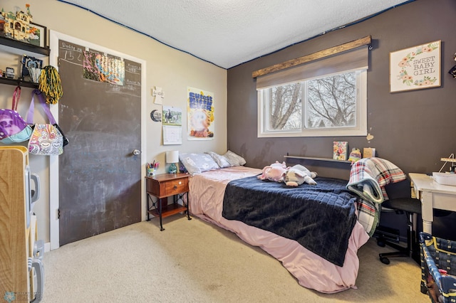 bedroom featuring carpet flooring and a textured ceiling