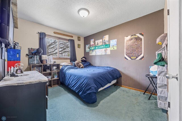 carpeted bedroom featuring a textured ceiling