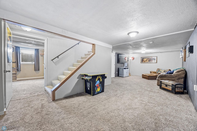 carpeted living room with stairway and a textured ceiling