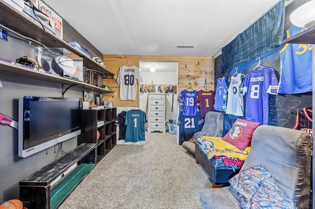 living area featuring carpet and a textured ceiling
