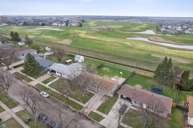 aerial view of property's location featuring a nearby body of water, a local golf course, and nearby suburban area