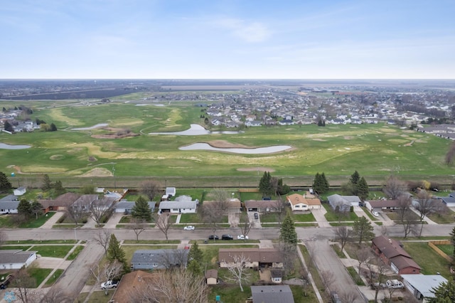view of property location with nearby suburban area, a large body of water, and a golf club
