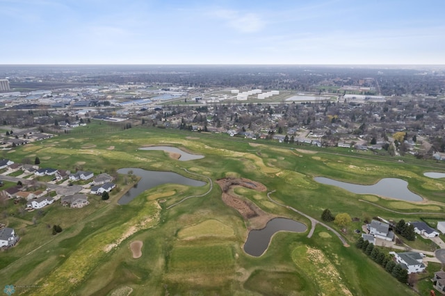 view of property location with nearby suburban area, a large body of water, and a golf club
