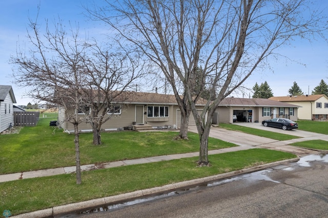 ranch-style house featuring concrete driveway, a front yard, and an attached garage