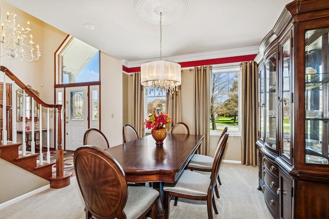 dining area with baseboards, a chandelier, ornamental molding, light carpet, and stairs