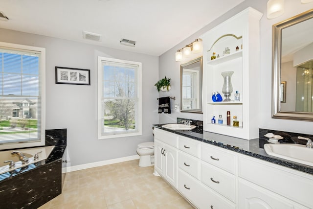 bathroom with visible vents, a healthy amount of sunlight, and a sink