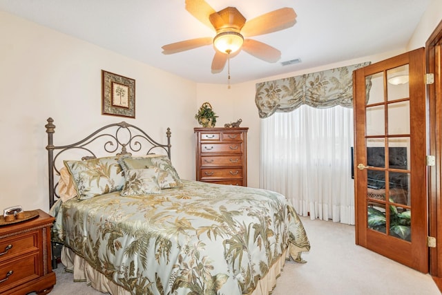 bedroom with ceiling fan, visible vents, and light carpet