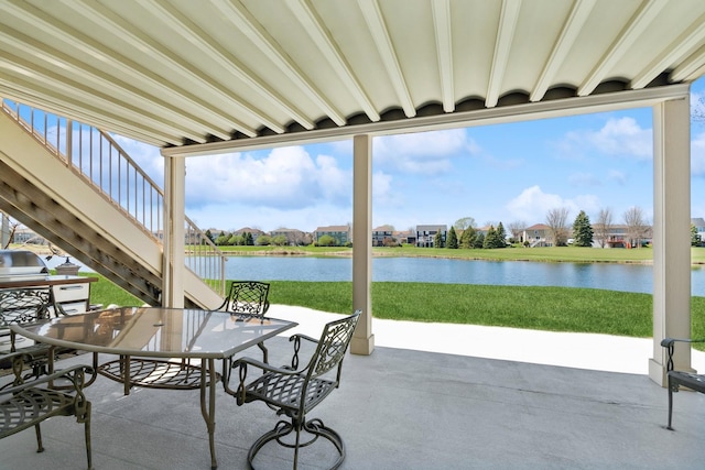 view of patio / terrace with stairs and a water view