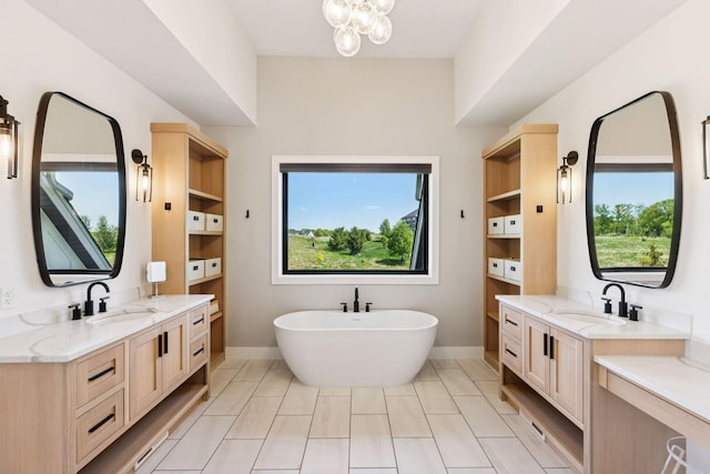 7450 73rd Ct N, Grant, MN 55082 - bathroom featuring two vanities, a freestanding tub, a chandelier, and baseboards