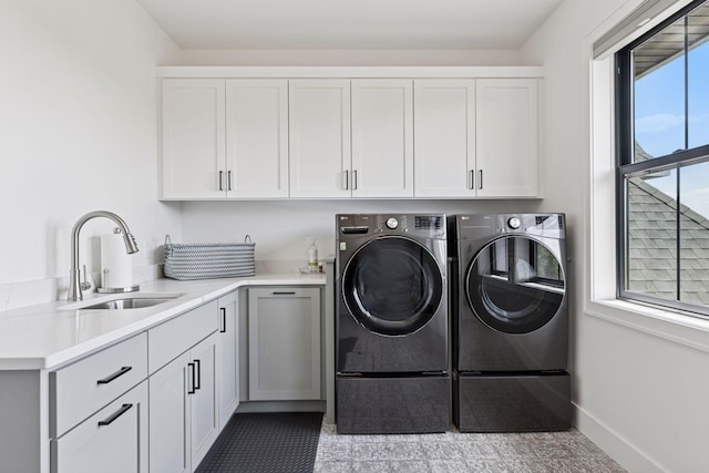 7450 73rd Ct N, Grant, MN 55082 - washroom featuring cabinet space, washer and clothes dryer, and baseboards