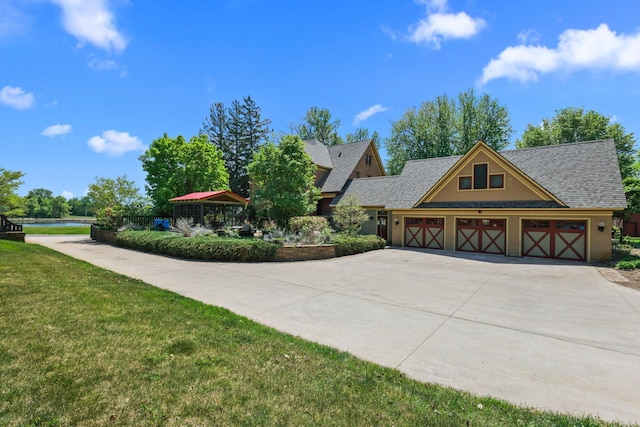 3375 Stark Rd NE, Cambridge Twp, MN 55008 - view of front of home with driveway, a garage, a front yard, stucco siding, and a shingled roof
