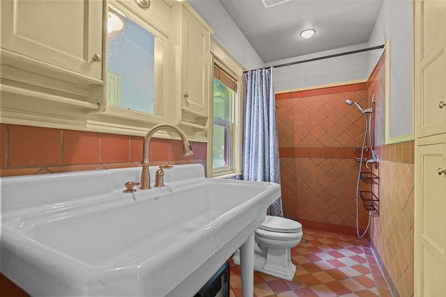 3375 Stark Rd NE, Cambridge Twp, MN 55008 - bathroom featuring tile walls, a tile shower, and a wainscoted wall