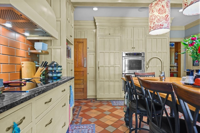 3375 Stark Rd NE, Cambridge Twp, MN 55008 - kitchen featuring custom exhaust hood, tasteful backsplash, black electric cooktop, cream cabinets, and tile patterned flooring