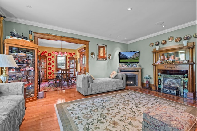 3375 Stark Rd NE, Cambridge Twp, MN 55008 - living area with a lit fireplace, wood finished floors, recessed lighting, and ornamental molding