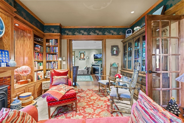 3375 Stark Rd NE, Cambridge Twp, MN 55008 - living area with a brick fireplace, crown molding, built in shelves, and wood finished floors
