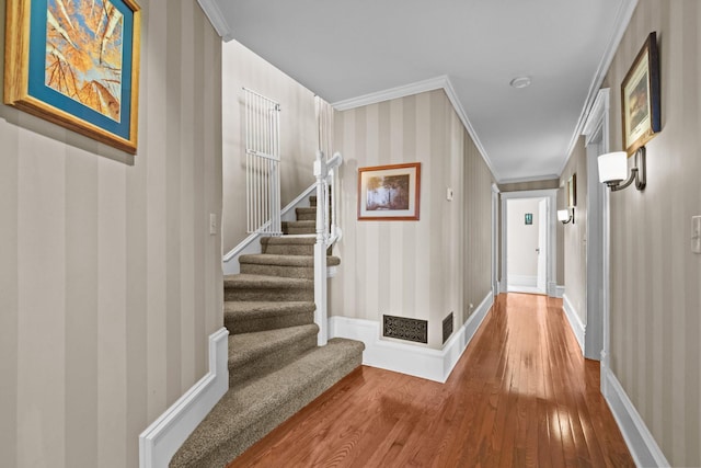 3375 Stark Rd NE, Cambridge Twp, MN 55008 - hall featuring wallpapered walls, wood finished floors, stairs, and ornamental molding