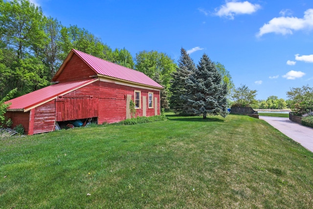 3375 Stark Rd NE, Cambridge Twp, MN 55008 - view of home's exterior with a yard, a metal roof, a barn, and an outbuilding
