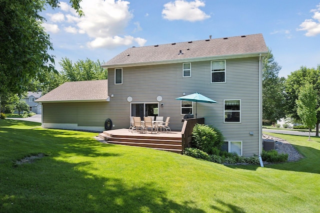 back of property featuring roof with shingles, a wooden deck, outdoor dining area, and a yard