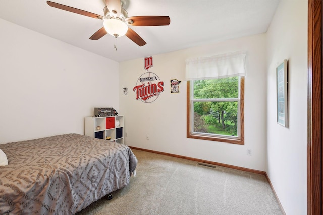 carpeted bedroom featuring visible vents, baseboards, and ceiling fan