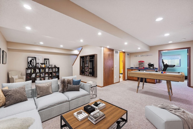 carpeted living room with recessed lighting and baseboards