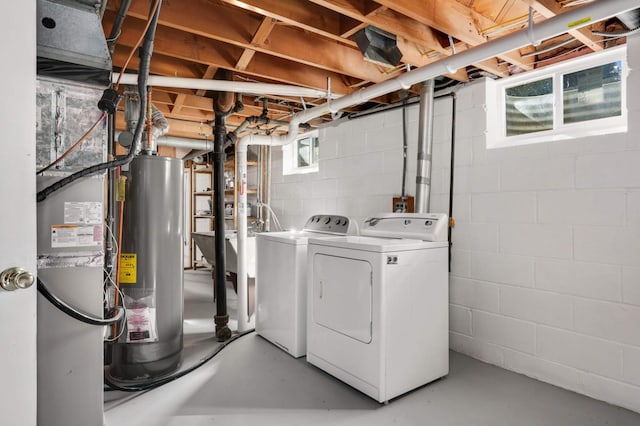 washroom with washer and dryer, water heater, and laundry area