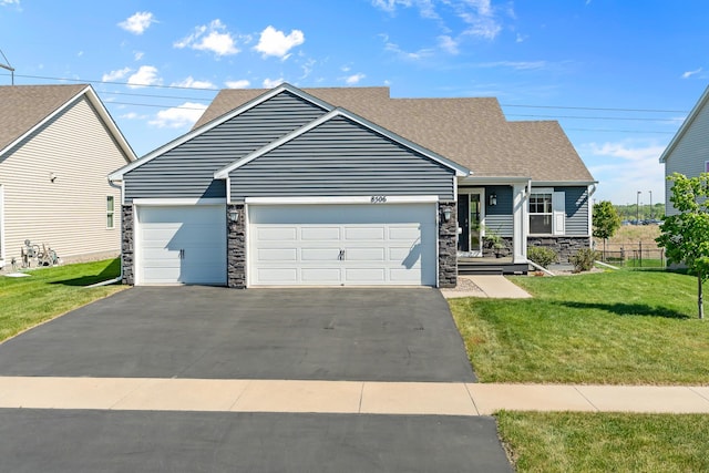 8506 Titanium Cir, Woodbury, MN 55129 - view of front of property with stone siding, driveway, a front lawn, an attached garage, and a shingled roof