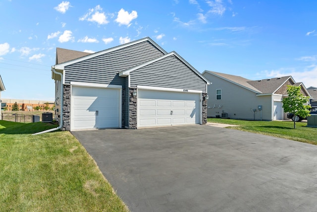 8506 Titanium Cir, Woodbury, MN 55129 - ranch-style home featuring driveway, central AC unit, a garage, and stone siding