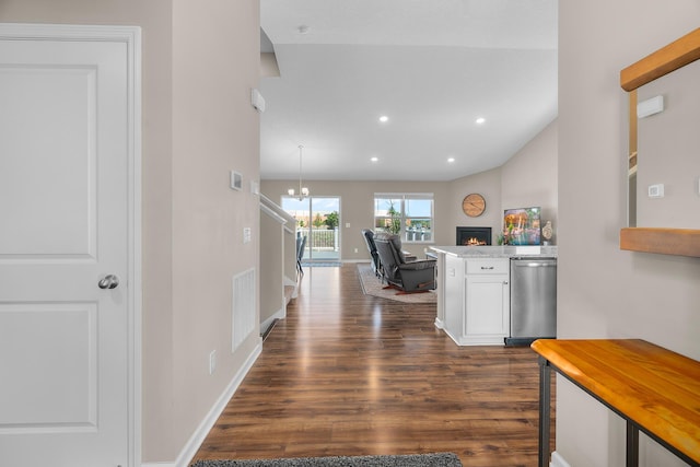 8506 Titanium Cir, Woodbury, MN 55129 - hall featuring dark wood-type flooring, recessed lighting, baseboards, a chandelier, and vaulted ceiling