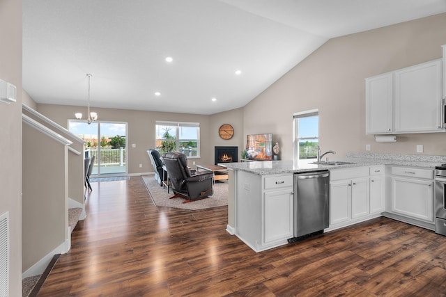 8506 Titanium Cir, Woodbury, MN 55129 - kitchen featuring dishwasher, vaulted ceiling, a peninsula, a lit fireplace, and dark wood-style flooring