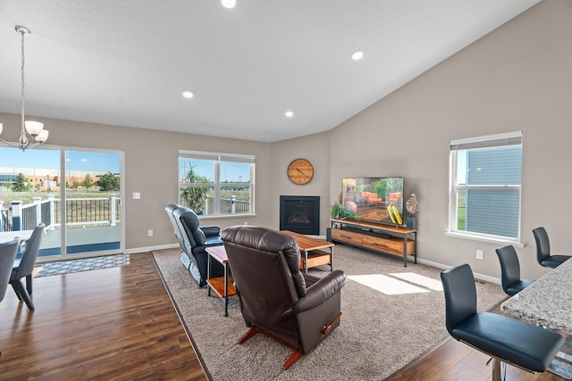 8506 Titanium Cir, Woodbury, MN 55129 - living room with a chandelier, baseboards, dark wood-type flooring, recessed lighting, and lofted ceiling