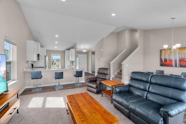 8506 Titanium Cir, Woodbury, MN 55129 - living room featuring lofted ceiling, a chandelier, recessed lighting, stairway, and baseboards