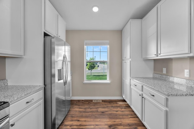 8506 Titanium Cir, Woodbury, MN 55129 - kitchen with stainless steel fridge, dark wood-type flooring, white cabinets, baseboards, and recessed lighting
