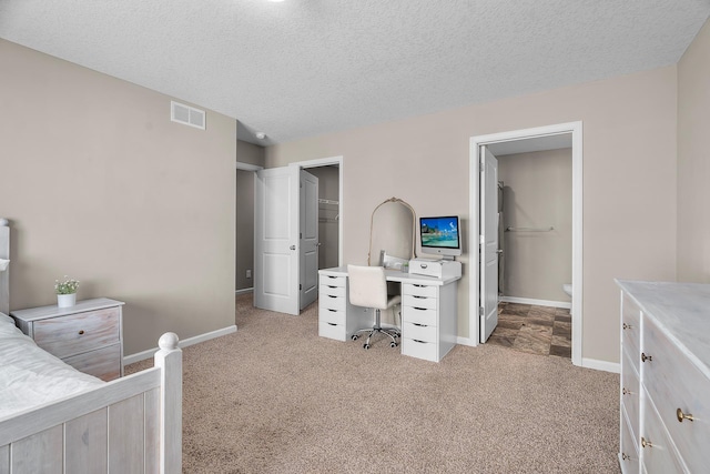 8506 Titanium Cir, Woodbury, MN 55129 - carpeted bedroom featuring an office area, a textured ceiling, a spacious closet, baseboards, and a closet