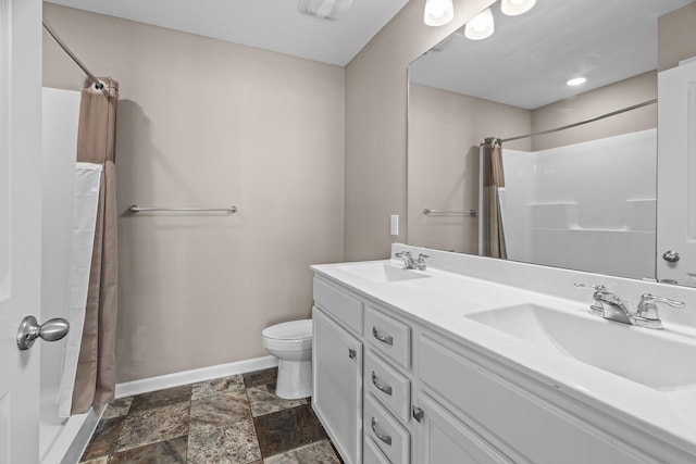 8506 Titanium Cir, Woodbury, MN 55129 - full bath with baseboards, a shower with curtain, double vanity, and toilet