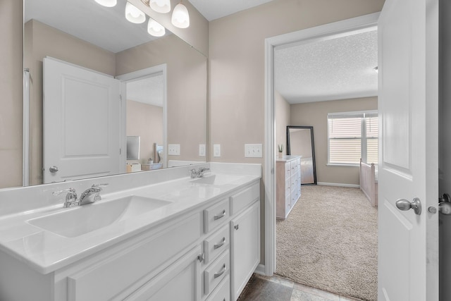 8506 Titanium Cir, Woodbury, MN 55129 - full bath with double vanity, a textured ceiling, baseboards, and ensuite bathroom