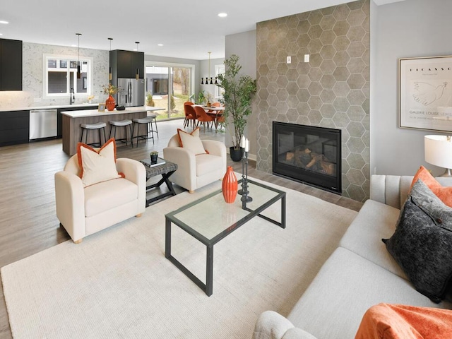 14913 Oakwood Dr, Burnsville, MN 55306 - living area with a healthy amount of sunlight, a stone fireplace, light wood finished floors, and recessed lighting