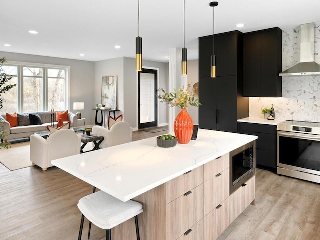 14913 Oakwood Dr, Burnsville, MN 55306 - kitchen with light wood-style floors, wall chimney exhaust hood, stainless steel appliances, and modern cabinets