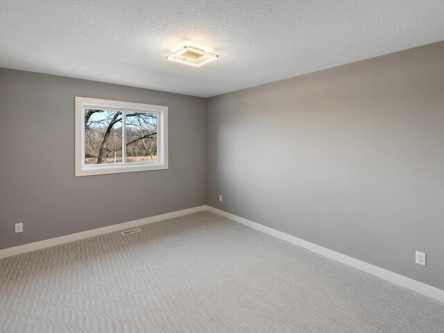 14913 Oakwood Dr, Burnsville, MN 55306 - carpeted empty room featuring baseboards, a textured ceiling, and visible vents