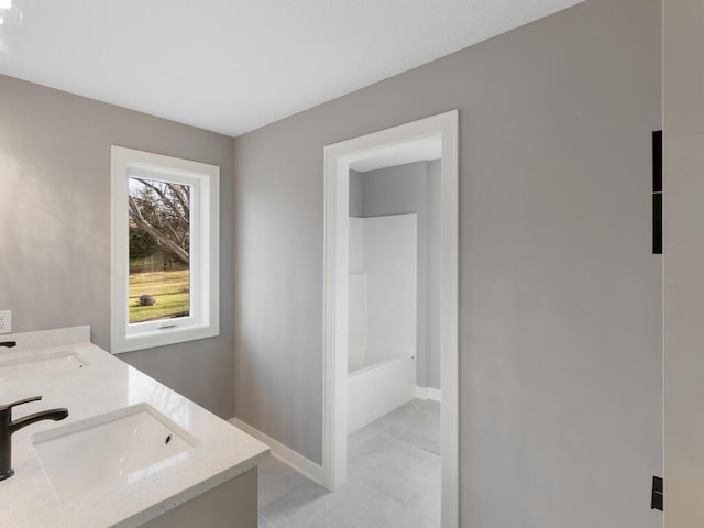 14913 Oakwood Dr, Burnsville, MN 55306 - full bath with a bath, baseboards, a sink, and double vanity