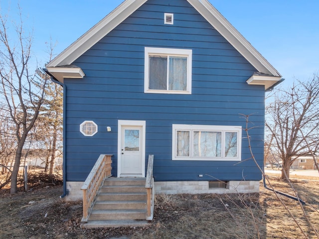 rear view of property featuring entry steps